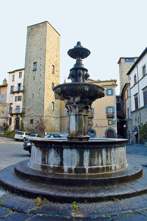 Piazza Gesù con la fontana e, sullo sfondo, la Torre del Borgognone.